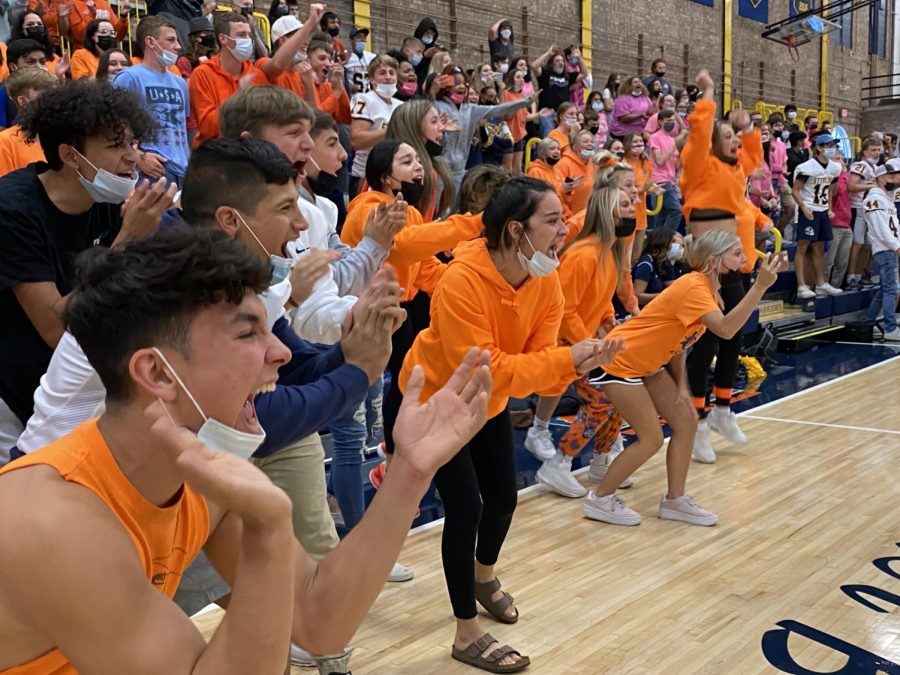 Juniors cheer for their classmates in the tug of war during the homecoming pre-assembly. Assemblies were added back in for homecoming week this year.