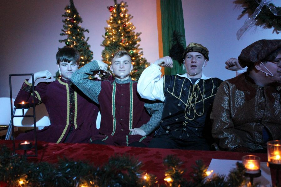 Freshmen Drew Nettleton, Cole Stumpenhorst and sophomore Ben Boze flex during the final madrigal performance of the year. The madrigals put on three stellar shows. 