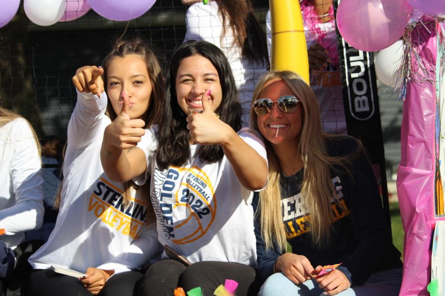 Seniors Aubrianna Menchaca, Mallory Osborn, and Julia Thormeyer throw candy during the Homecoming Parade. Students from sterling public schools collaborate together for a cohesive parade. 