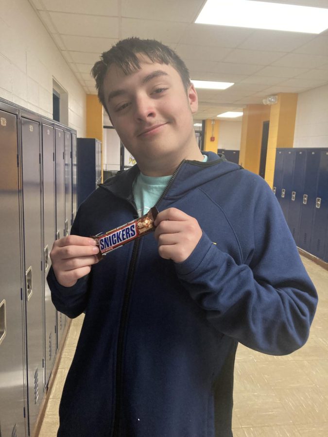 Sophomore and candy expert Austin Fox displays one of his least favorite candies. Fox sampled many types of Halloween favorites in order to rank them.