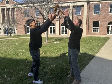 Seniors Antonio Tablante and AJ Lawrence throw leaves in the air. Fall is their favorite time of the year.