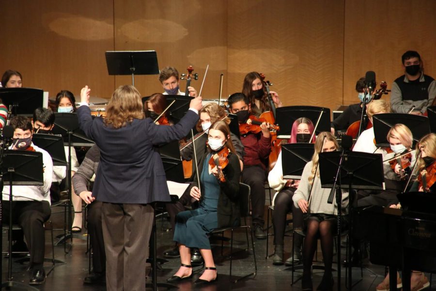 S.H.S. orchestra director Erik Oberg preps the orchestra ensemble to play a piece of music during last years holiday concert. Each music group played two to three pieces individually before performing one cohesive piece at the end of the concert.