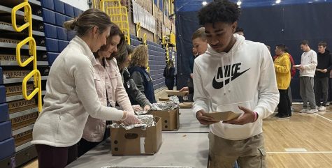 Sophomore Kaedon Phillips picks up his chicken George lunch in the field house. Phillips was one of many students that received chicken George for having good grades, great attendance, and no discipline referrals.