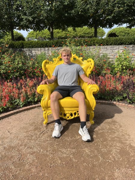 Junior Cole Stumpenhorst sits in yellow chair. Stumpenhorst came across this chair when walking around the different gardens.