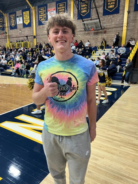Senior Jadon Jones shows off his candlelight shirt. Jones wore his shirt to the basketball game against Quincy.
