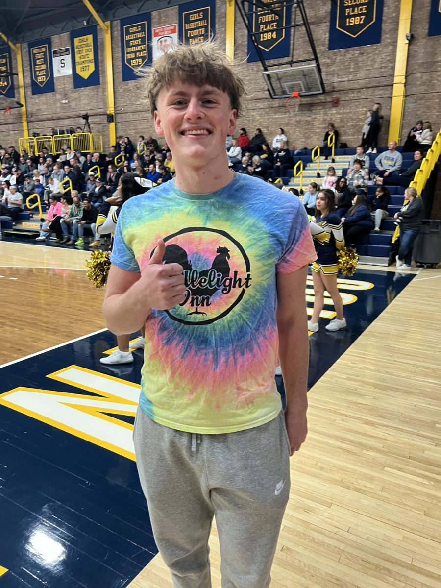 Senior+Jadon+Jones+shows+off+his+candlelight+shirt.+Jones+wore+his+shirt+to+the+basketball+game+against+Quincy.