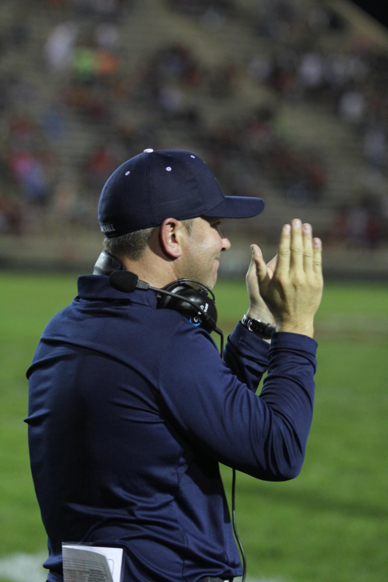 Coach Jonathan Schlemmer claps after a big win against Pekin in 2018.