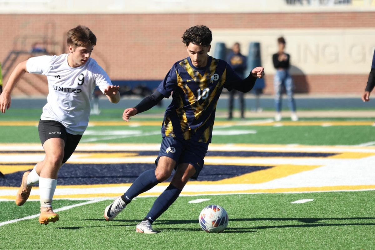 Senior Zain Khan fights against his opponent from Orion. This game was the boys soccer team's first game of postseason. 