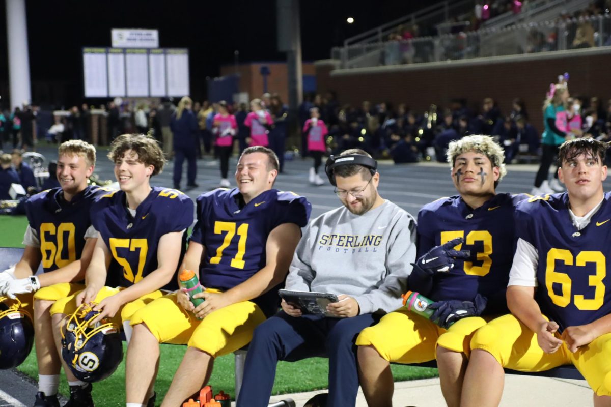 The Golden Warrior offensive line listens to Coach Kinnicutt. The Warriors went on to beat Rock Island 47-14.