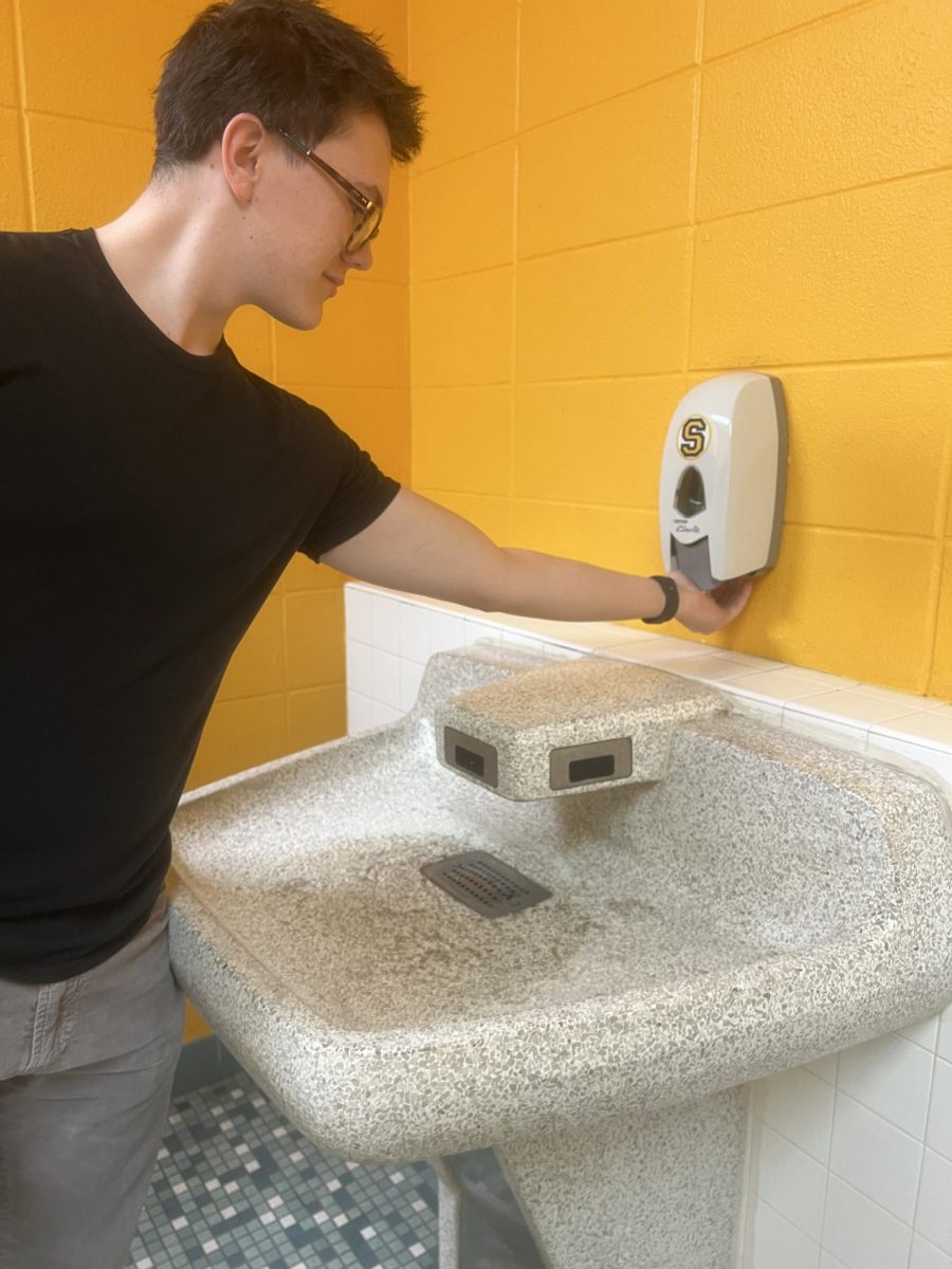 Senior Zackary Koppien washes his hands with soap and water. 