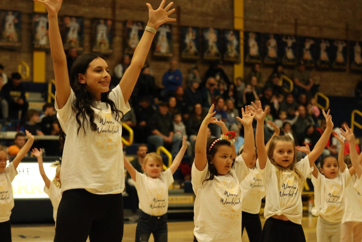 Sophomore Kiralyn Fisher dances with the 5-6 age group. The dance team members got to choose which age group they wanted to be with.