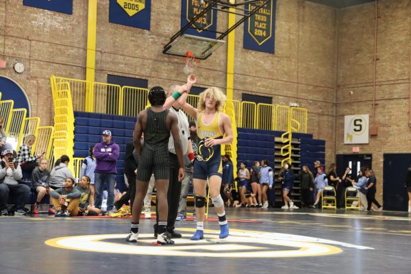 Senior Zyan Westbrook gets his hand raised after winning a match. Westbrook would go on to win the championship match.