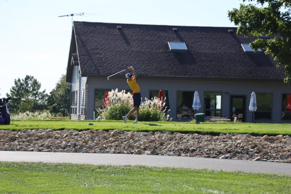 Senior Bryce Hartman tees off on the fourth hole at emerald hill golf course. Emerald Hill is the Golden Warriors golf teams home course.