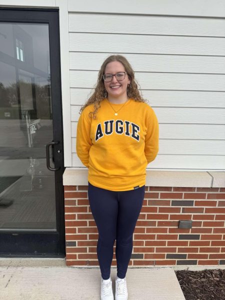 Samantha Knox represents Augustana College by wearing an "Auggie". Knox committed to Augustana on April 9th. 