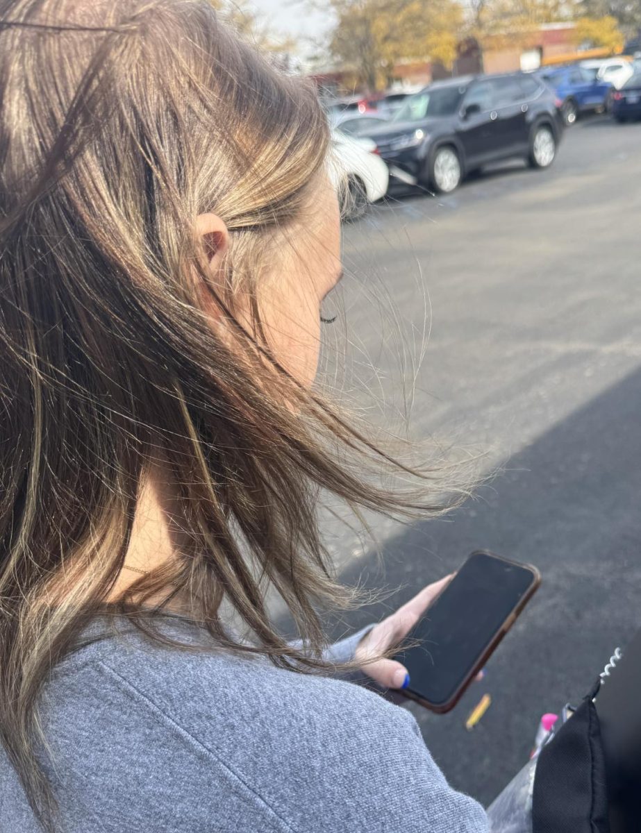 Senior Madison Stern using the new iPhone 26 update while walking home. She expressed her enjoyment of the new update.
